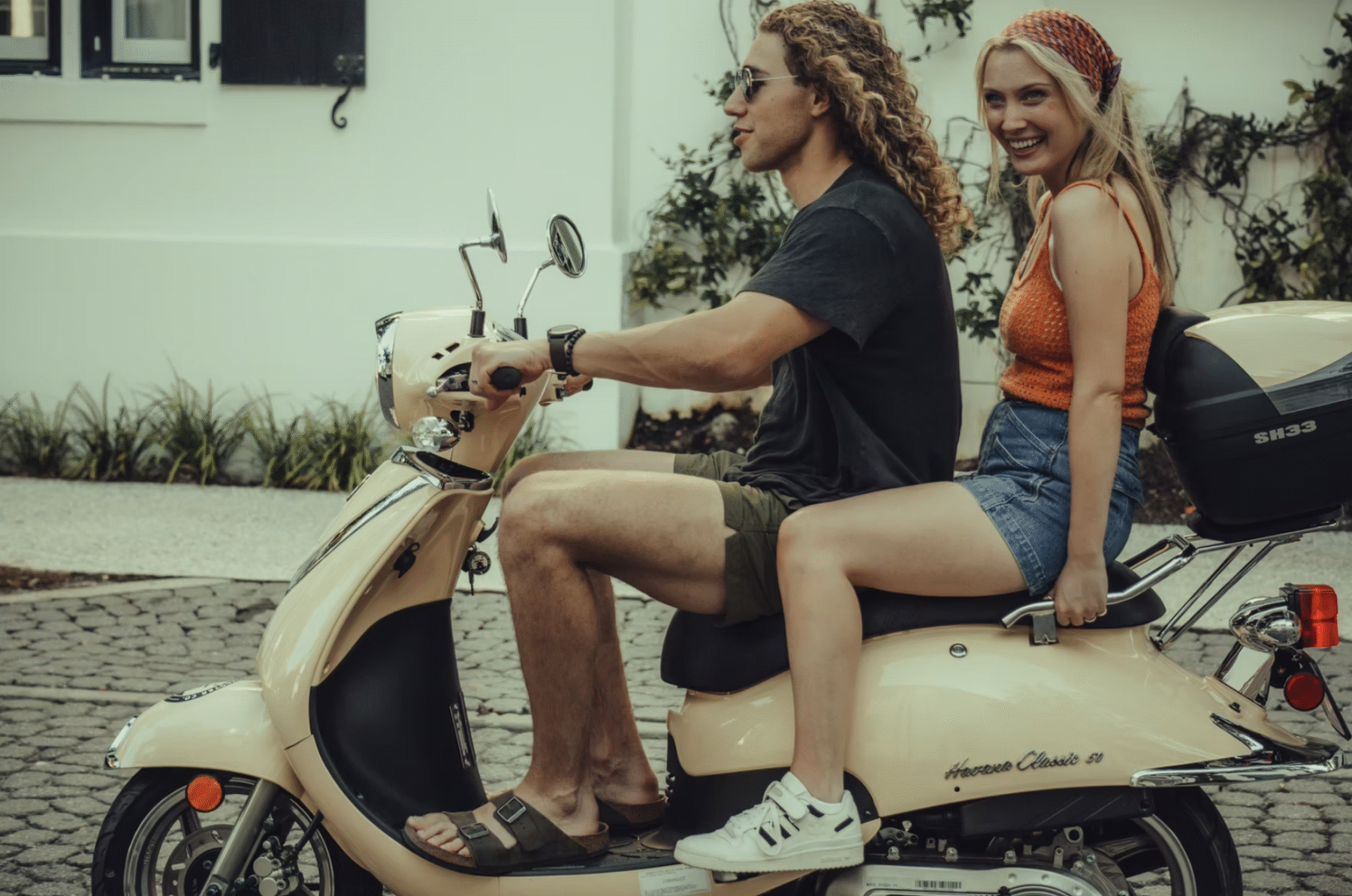A pair of bright, well-maintained scooters parked near the beach with turquoise waters in the background, showcasing Sandpiper Scooter Co.’s 30A scooter rentals—perfect for exploring scenic beach towns and coastal roads.